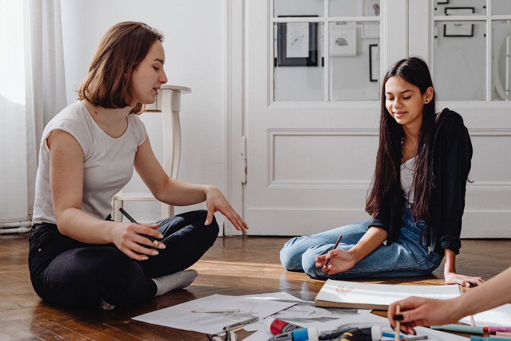 Friends Sitting On The Floor Talking