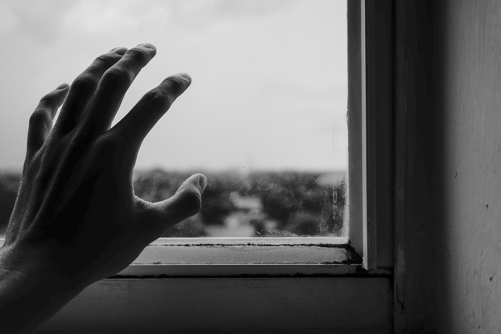 Hand Reaching Out To The Window