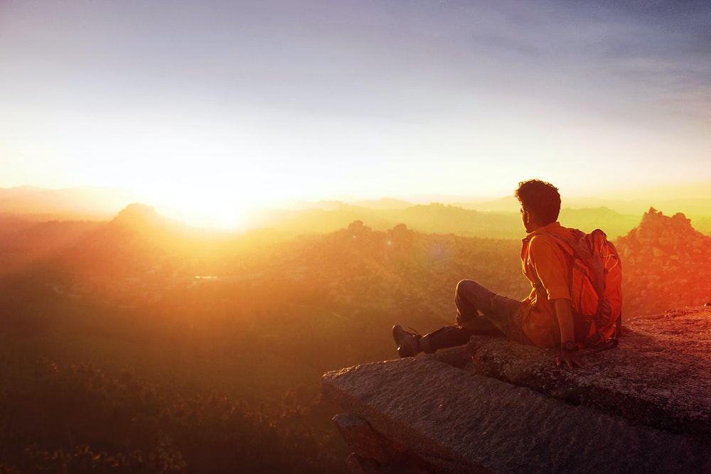 Man Facing The Sunrise