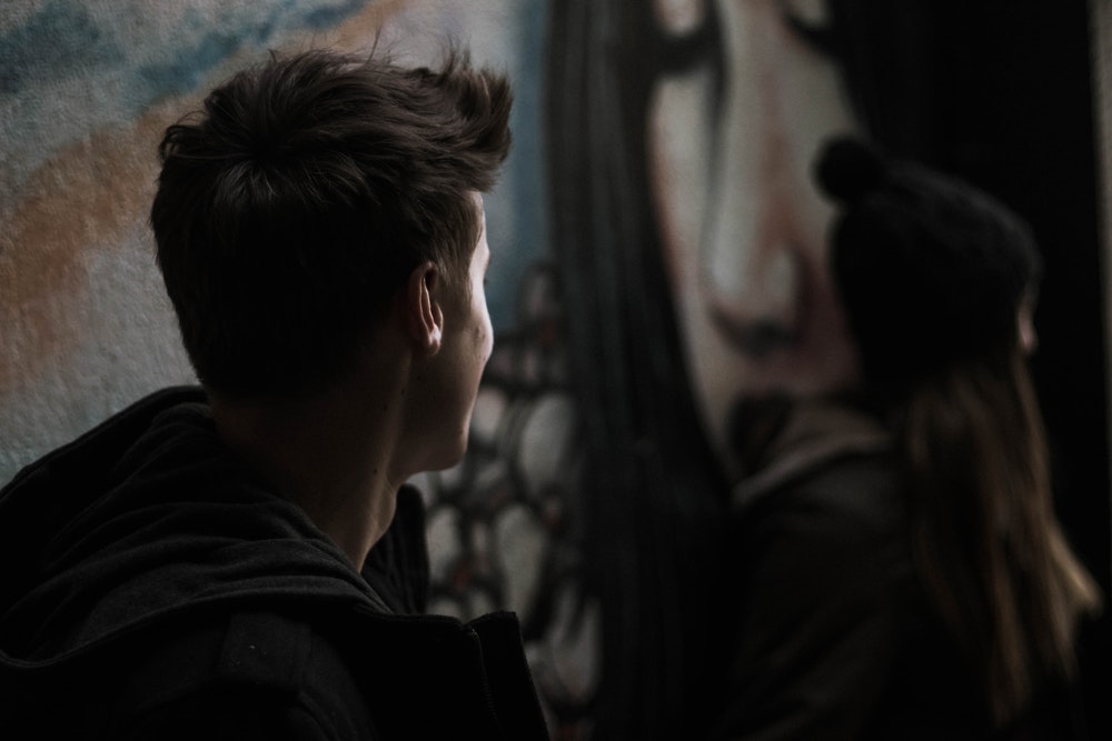 Man Looking Over A Woman