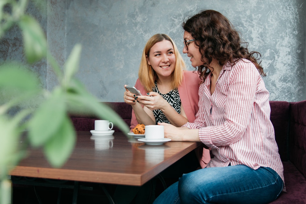 Women Talking While Smiling