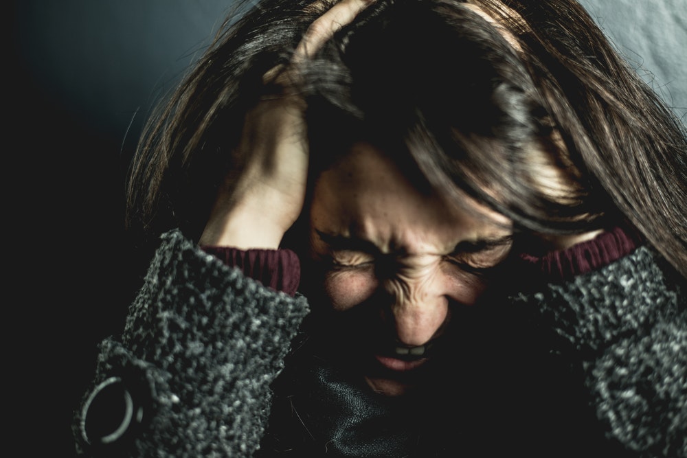 Frustrated Woman Gripping Her Head