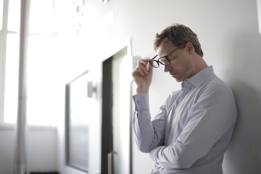 Man Holding His Glasses