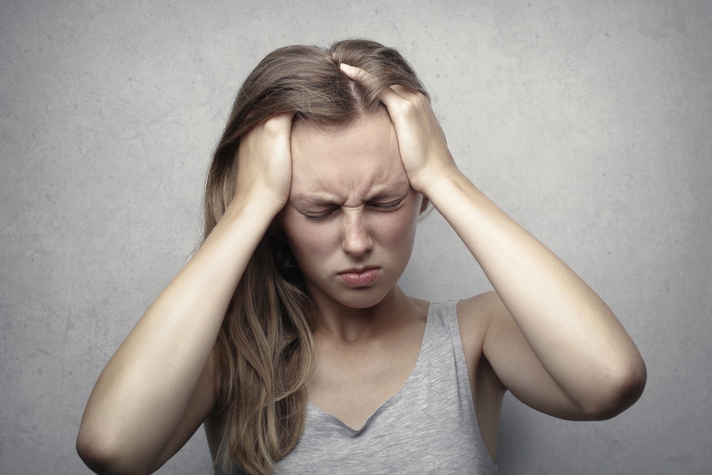 Woman Clutching Her Head