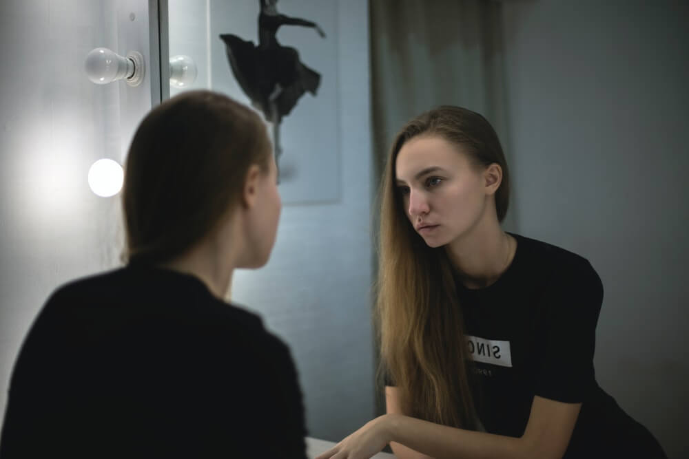 Woman Facing The Mirror