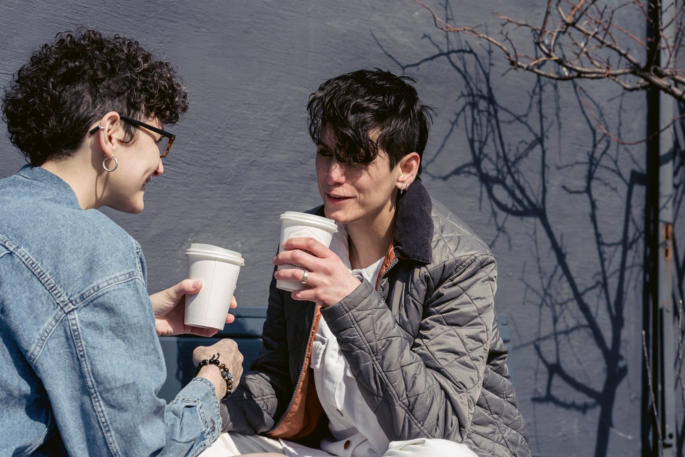 Friends Talking While Drinking Coffee
